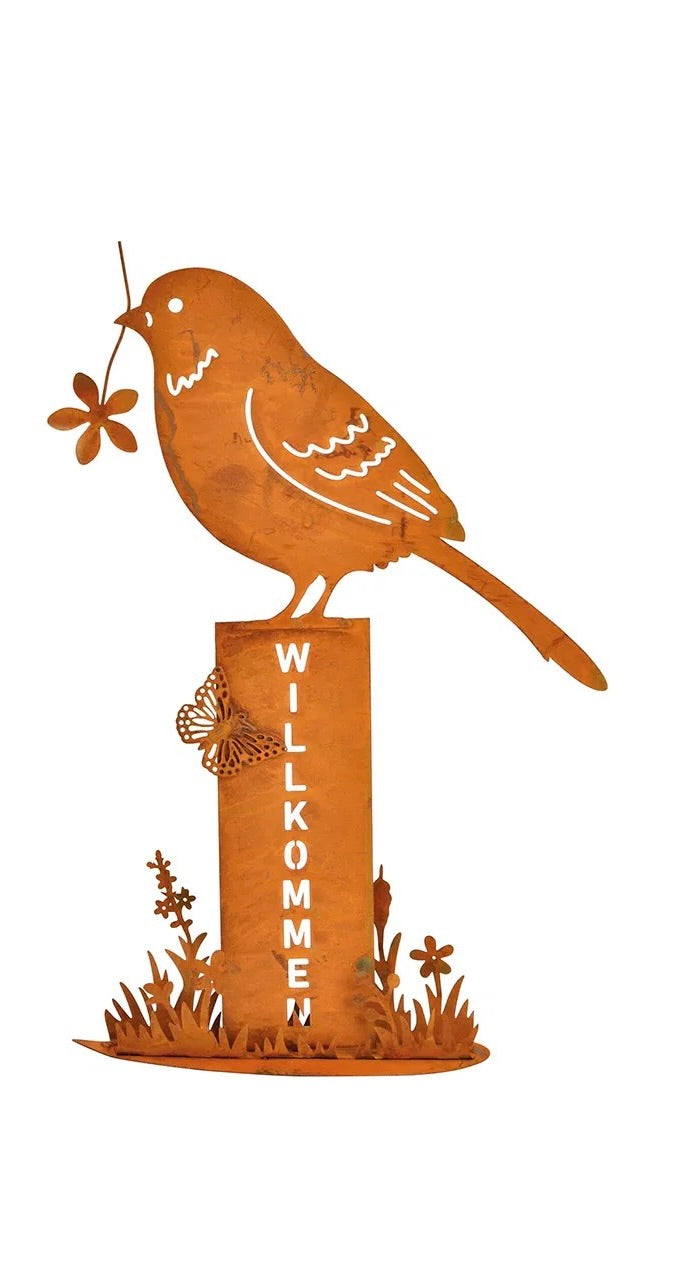 One metal bird stand with a rusty finish, featuring a bird holding a flower, mounted on posts with the word 'WELCOME' on it.