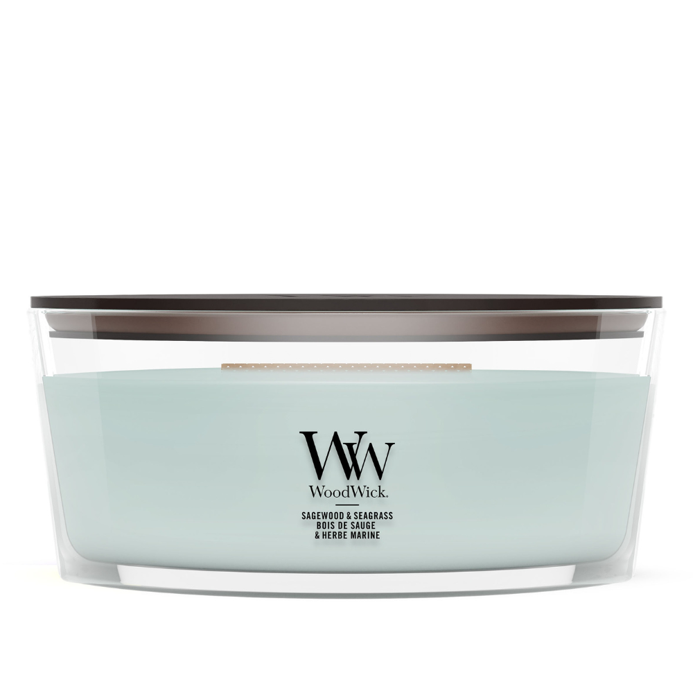 Sage Wood scented candle in a clear glass jar with a wooden lid.