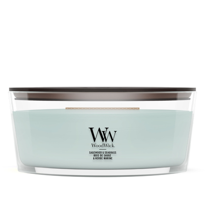 Sage Wood scented candle in a clear glass jar with a wooden lid.