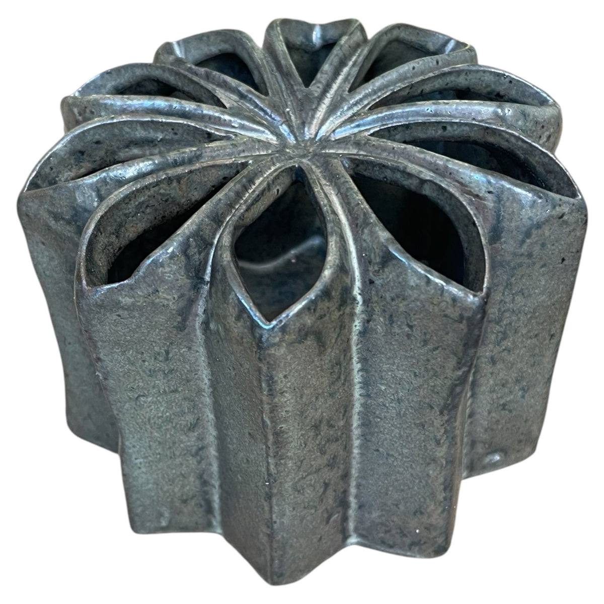 Decorative metal vase with a unique geometric design on a white background
