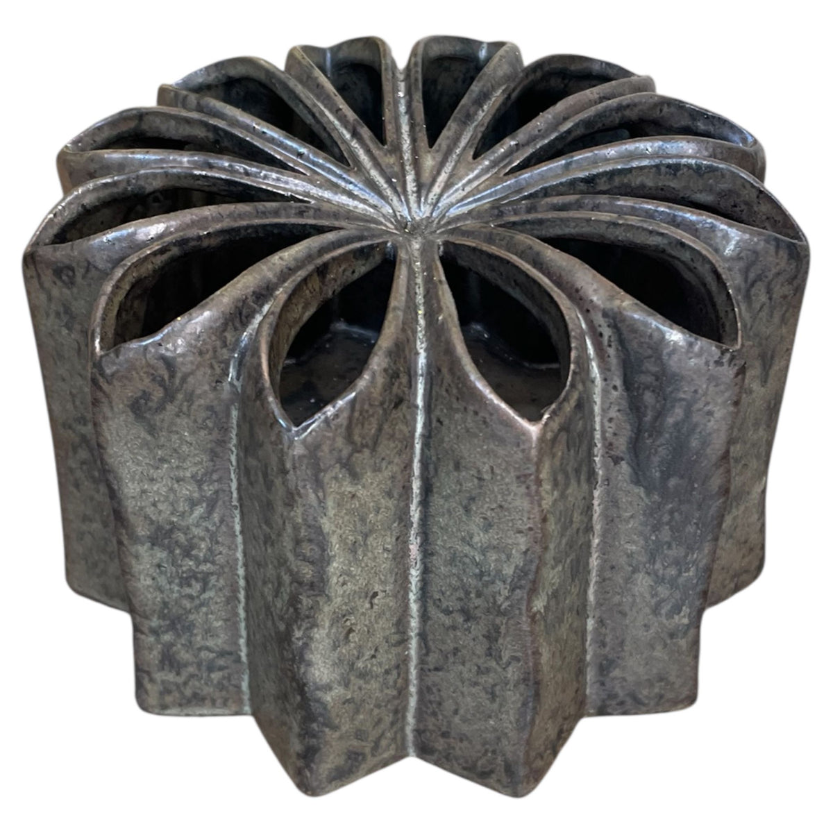Decorative metal object with a unique design on a white background