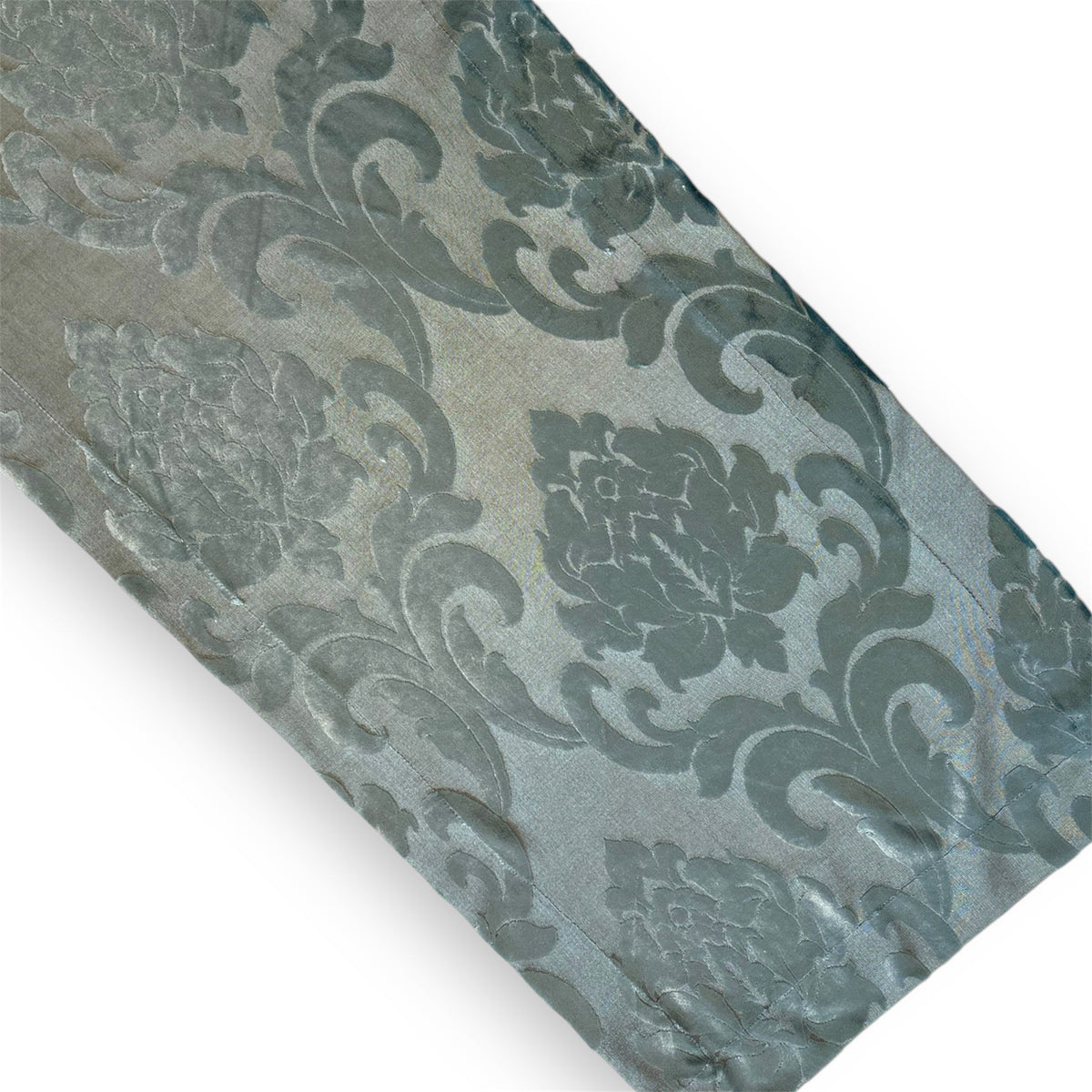 A silver-blue patterned runner with a floral design, likely used for decorative purposes.