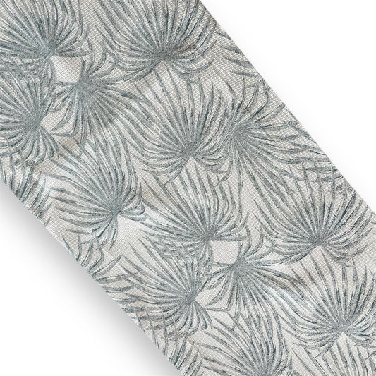 A silver-blue runner with a tropical palm leaf pattern.