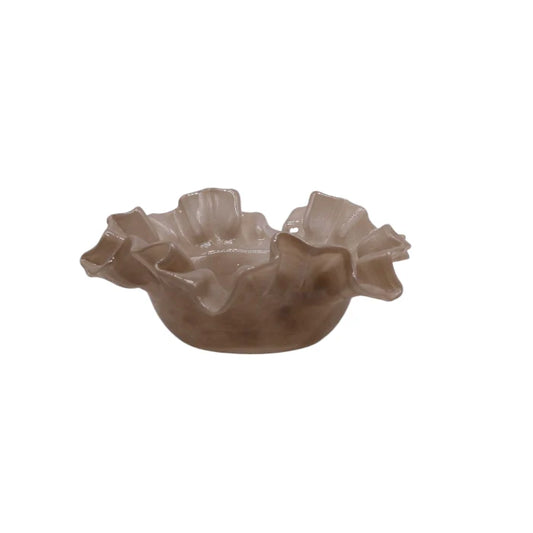 Decorative glass bowl with ruffled edge on a white background