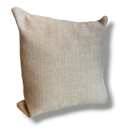 Square decorative throw pillow in a textured, natural beige linen weave, standing upright against a plain white background.