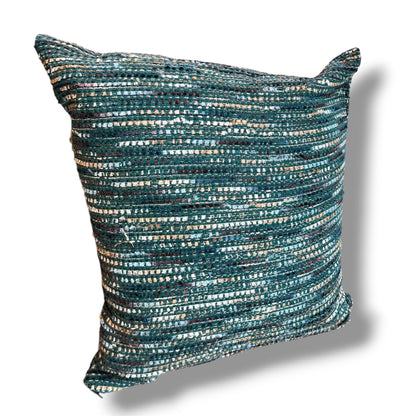 Square decorative throw pillow in a rich textured tweed weave featuring shades of ocean teal, emerald green, navy, and metallic silver threads against a plain white background.