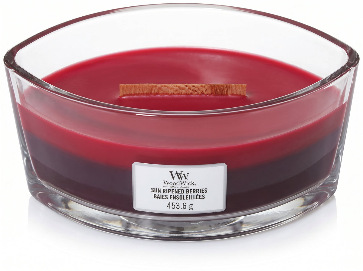 WoodWick Sun Ripened Berries candle in a clear glass jar with an open lid.