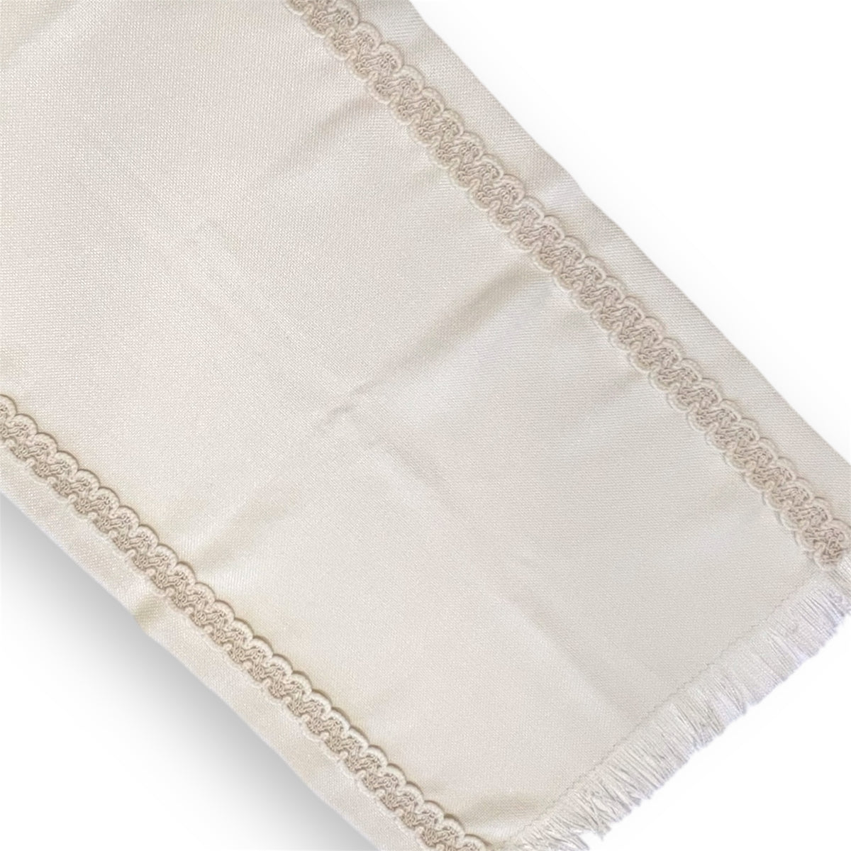 A beige lace table runner with a textured pattern and fringed edges.