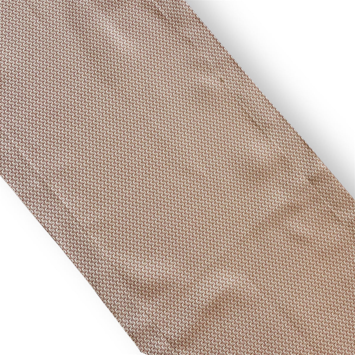 Close-up view of a textured woven linen table runner in a neutral taupe beige shade against a white background.