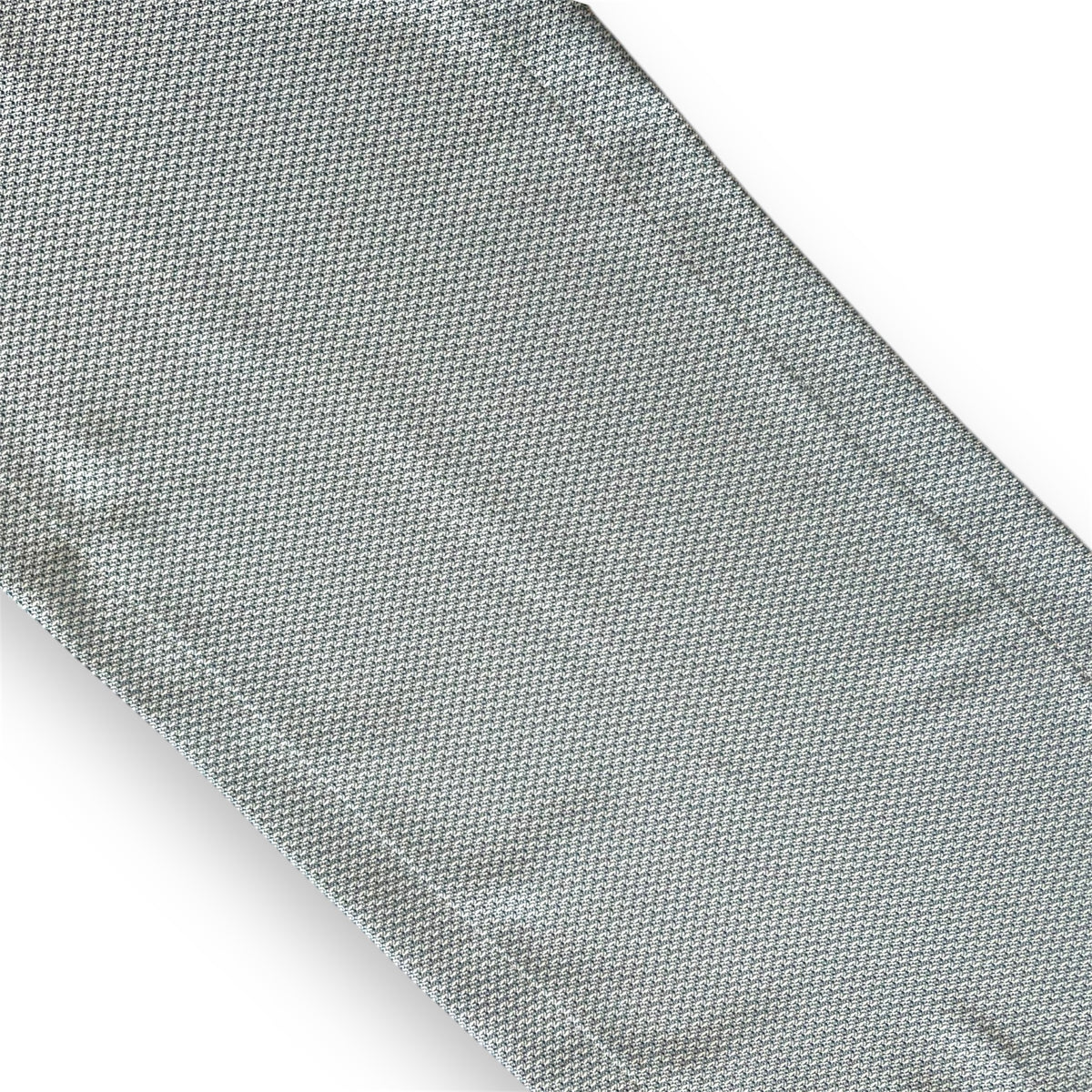 A close-up image of a textured turquoise runner with a focus on its fabric pattern and color.