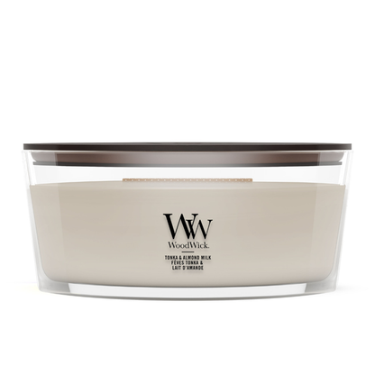 Soft Wool & Amber scented jar candle surrounded by cozy knit blanket layers.