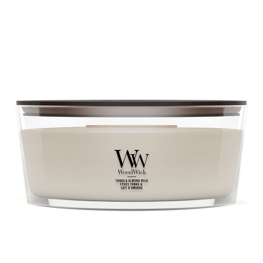 Soft Wool & Amber scented jar candle surrounded by cozy knit blanket layers.