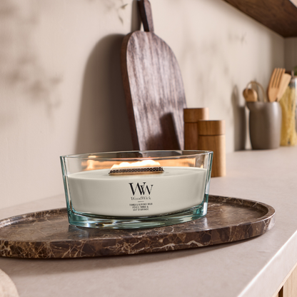 Soft Wool & Amber scented jar candle surrounded against decorative background