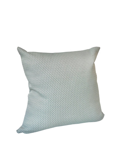 a square silver pillow with a subtle textured pattern