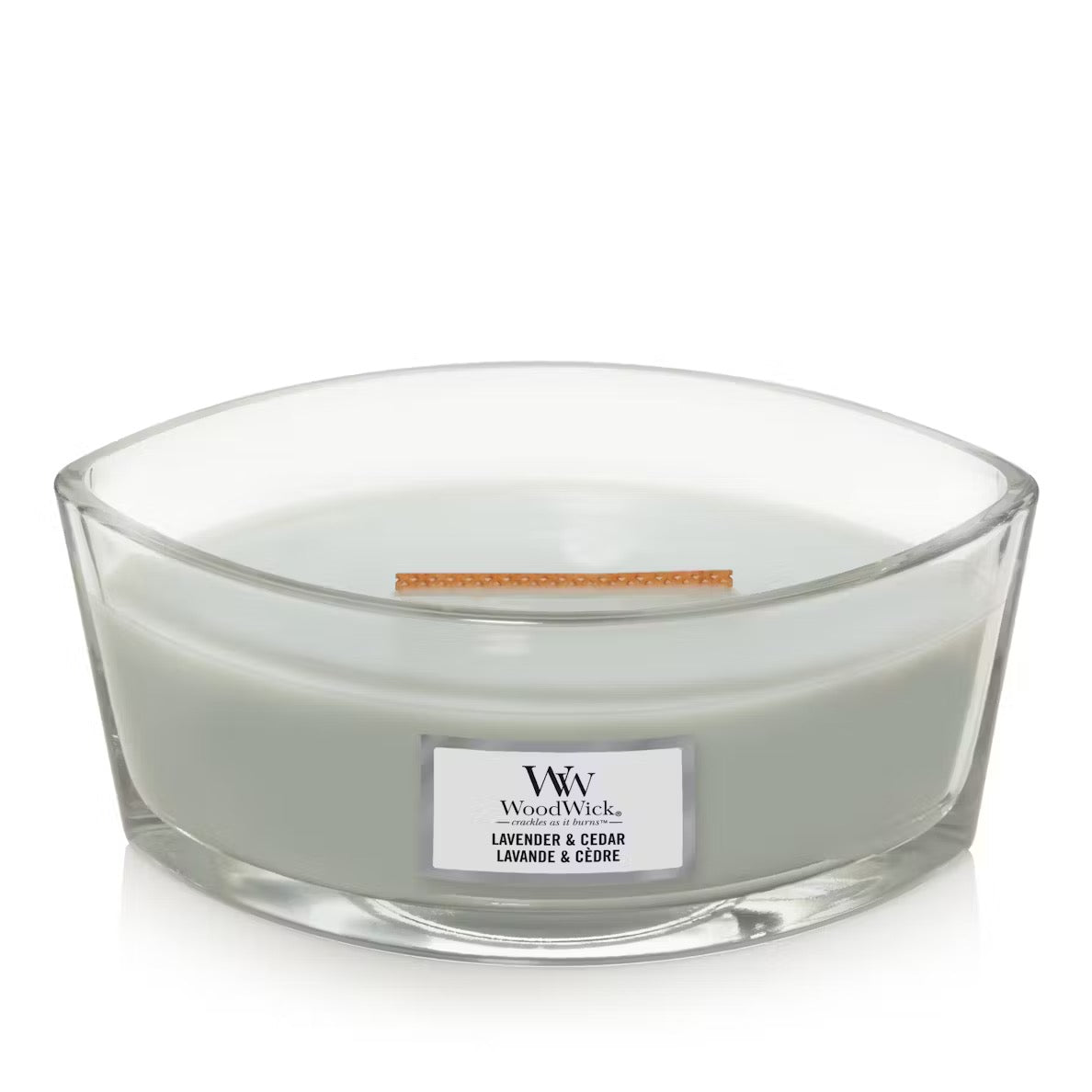Unlid WoodWick Lavender & Cedar Ellipse Jar Candle with light sage green wax, a wooden wick,  centered against a clean white background.