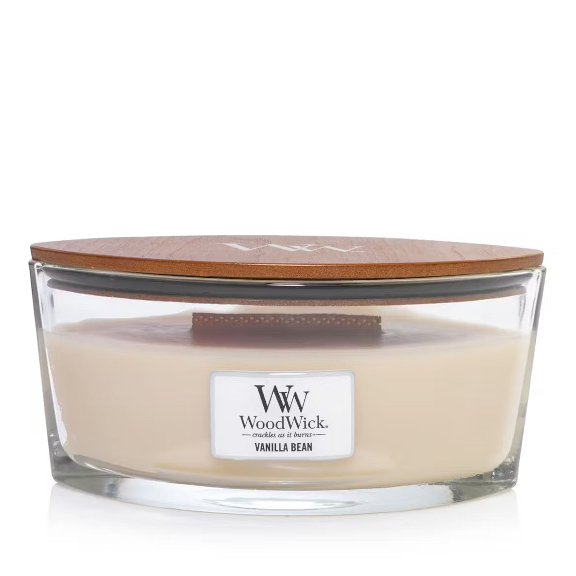 A clear ellipse-shaped jar candle with a brown wooden lid, labeled 'W. Woodwick Vanilla Bean'.