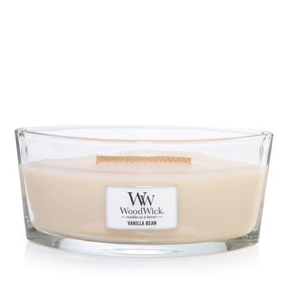 A clear ellipse-shaped jar candle with an opened lid, labeled 'W. Woodwick Vanilla Bean'.