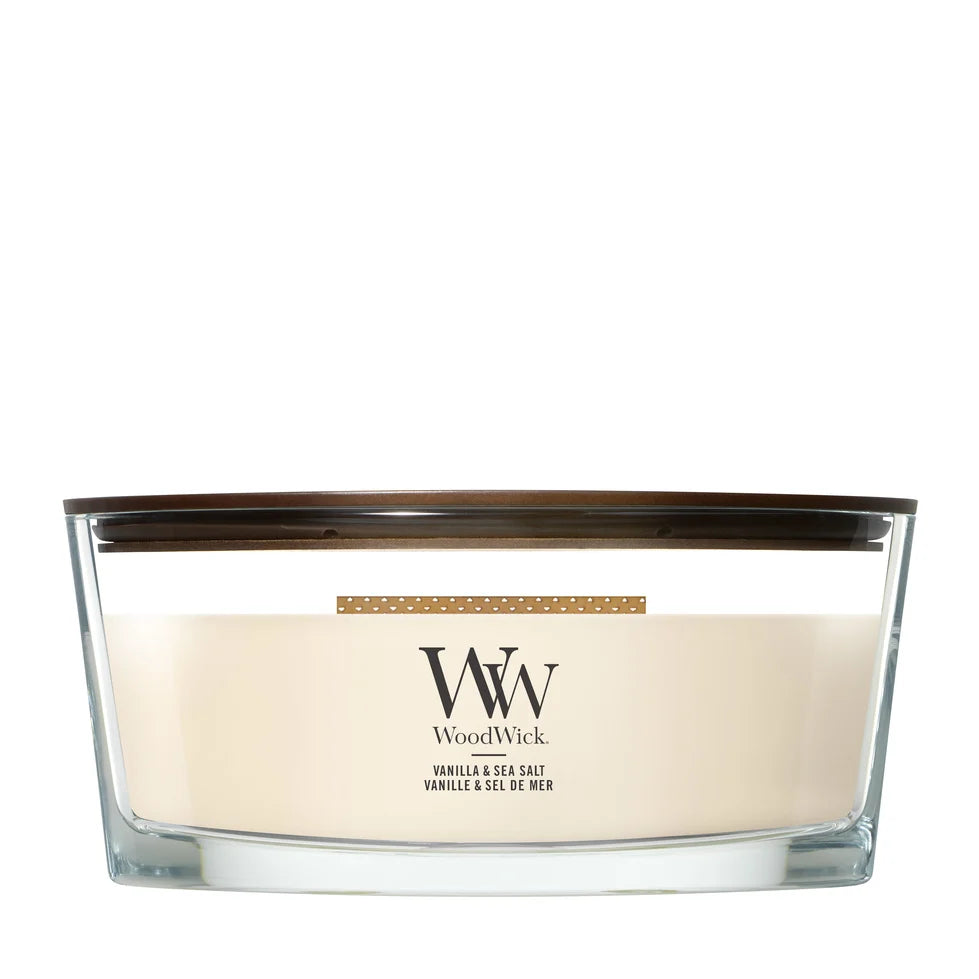 WoodWick Vanilla and Sea Salt ellipse candle in a clear glass jar with a wooden lid.