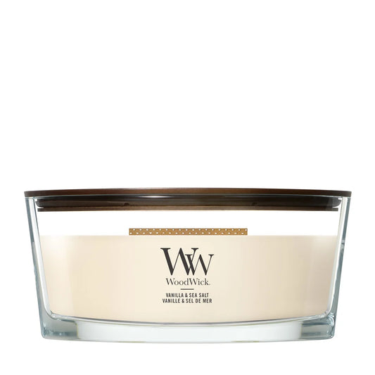 WoodWick Vanilla and Sea Salt ellipse candle in a clear glass jar with a wooden lid.