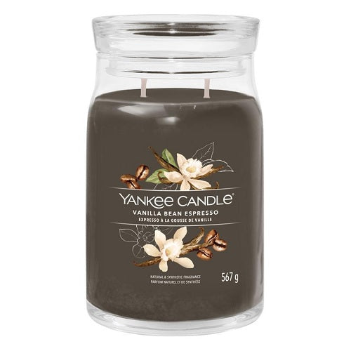 A Yankee Candle vanilla bean espresso candle in a clear glass jar with a brown label, showing the candle's weight of 550 grams.