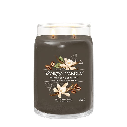 A Yankee Candle vanilla bean espresso candle in a clear glass jar with a brown label, showing the candle's weight of 550 grams.