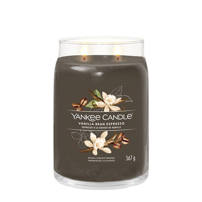 A Yankee Candle vanilla bean espresso candle in a clear glass jar with a brown label, showing the candle's weight of 550 grams.