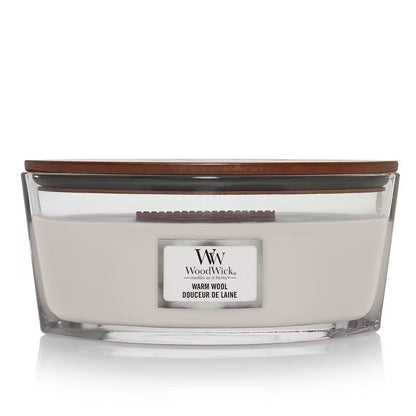 WoodWick Warm Wool Ellipse Jar Candle with cream-colored wax, a wooden wick, and a wooden lid centered against a clean white background.