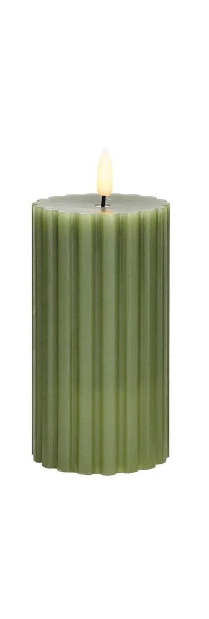 green LED wax candle with a flickering effect, in shape with a visible wick flame at the top.