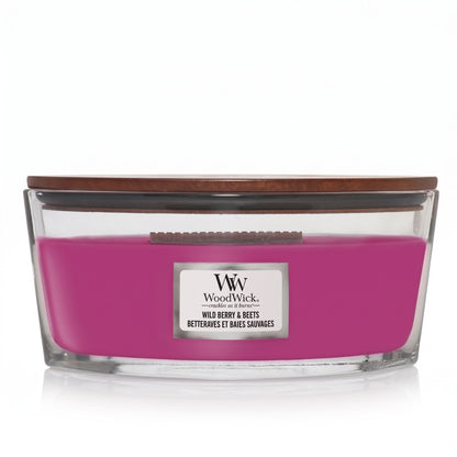 WoodWick Wild Berry and Beets candle in a clear glass jar with a wooden lid.