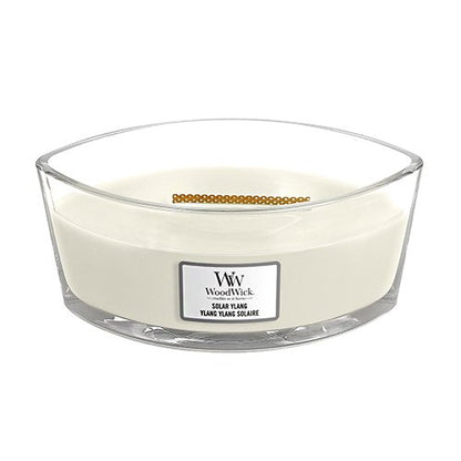 A square-shaped, beige-colored jar candle with an opened lid, labeled 'Woodwick Ylang Square'.