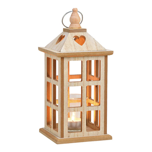 A wooden tea light holder with a glass base and a heart-shaped cut-out on top. It is lit from inside, showing a warm glow.