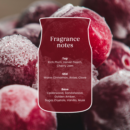 A close-up of frosted red fruits with a central label reading 'Fragrance notes' and listing scent components such as rich plum, velvet peach, cherry jam, warm cinnamon, anise, clove, cedarwood, sandalwood, golden amber, sugar crystals, vanilla, and musk.