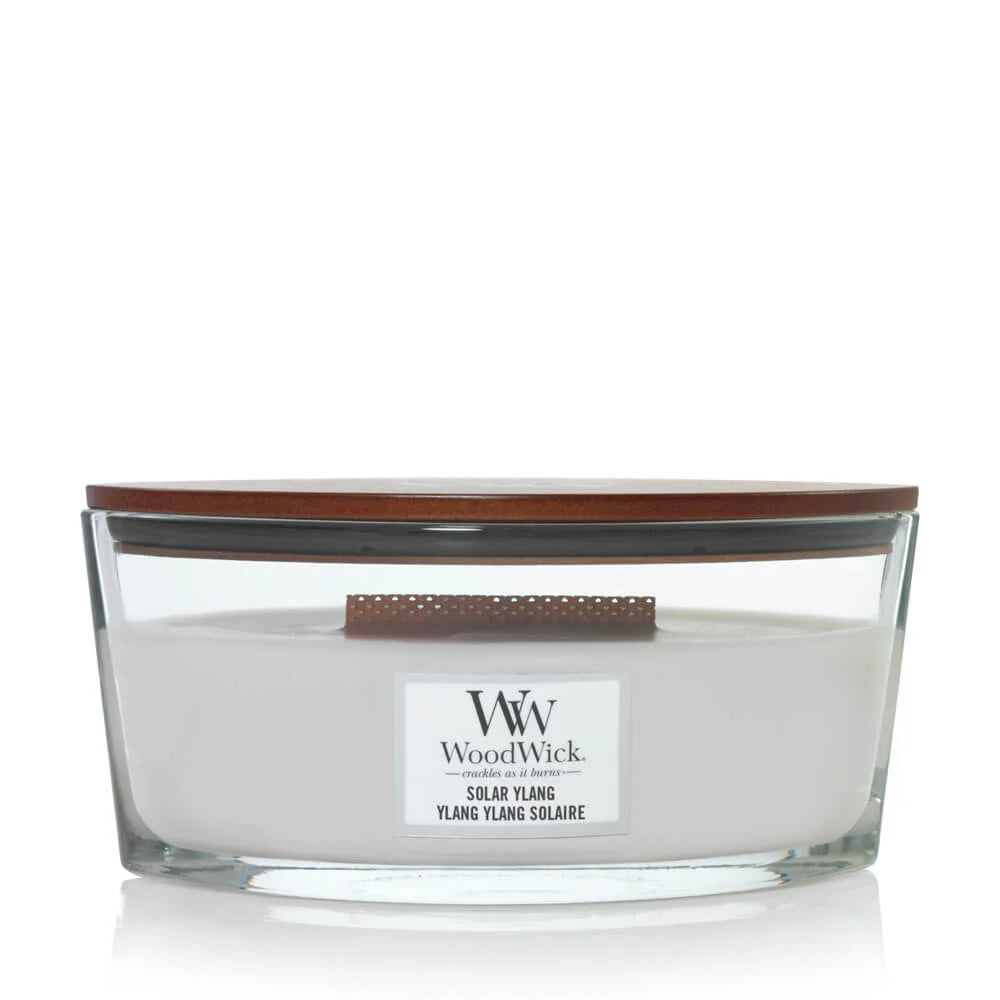 A square-shaped, beige-colored jar candle with a brown lid, labeled 'Woodwick Ylang Square'.