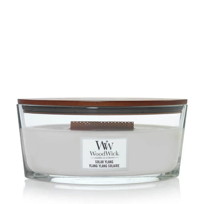 A square-shaped, beige-colored jar candle with a brown lid, labeled 'Woodwick Ylang Square'.