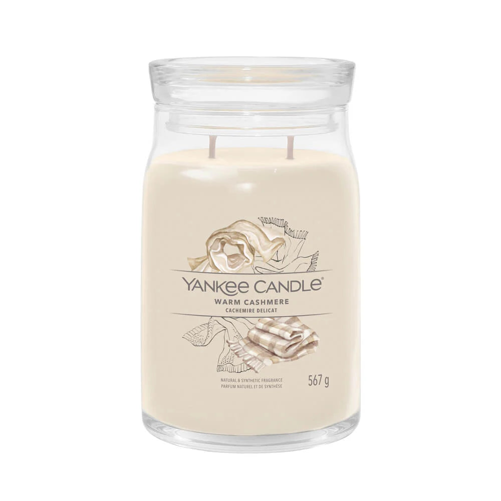 A beige Yankee Candle warm cashmere wax tart in a clear glass jar.