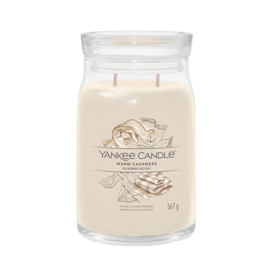 A beige Yankee Candle warm cashmere wax tart in a clear glass jar.