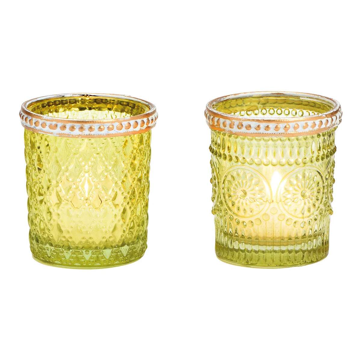 Two cylindrical glass candle holders with geometric patterns and brown rims, one with a green hue and the other with a transparent appearance, both containing lit candles.