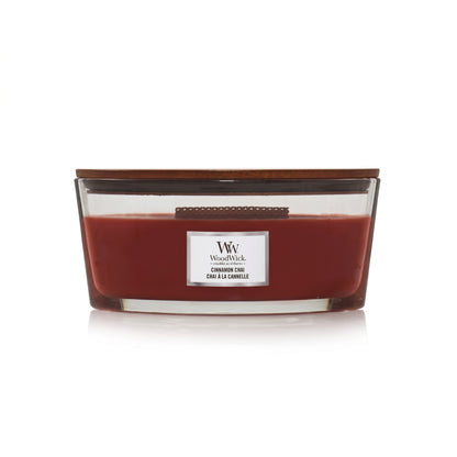WoodWick Cinnamon Chai candle in a clear glass jar with a wooden lid.