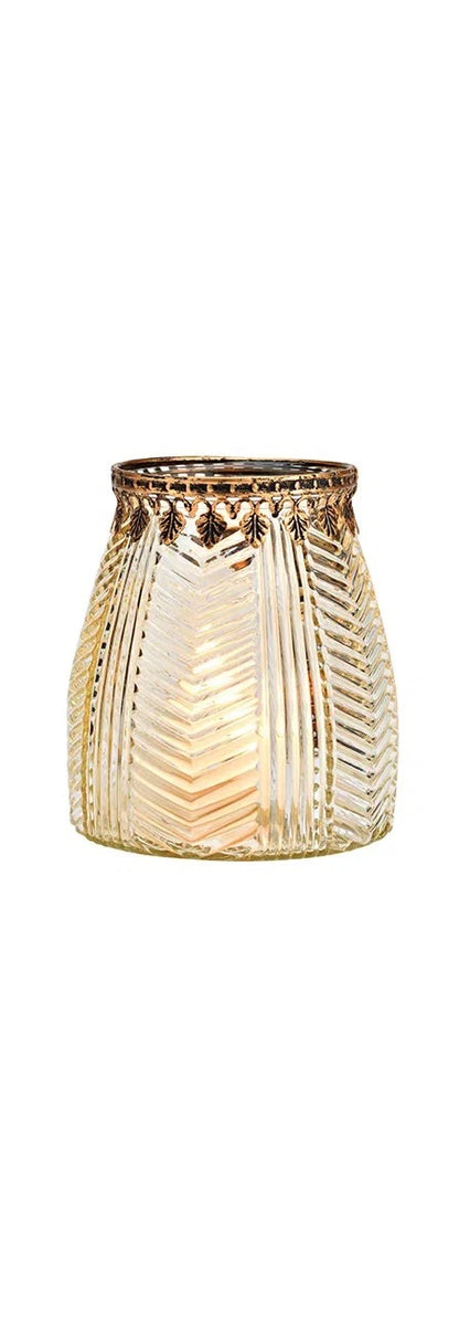 cylindrical brown glass windlight with geometric patterns, lit from the inside, showcasing a warm glow.