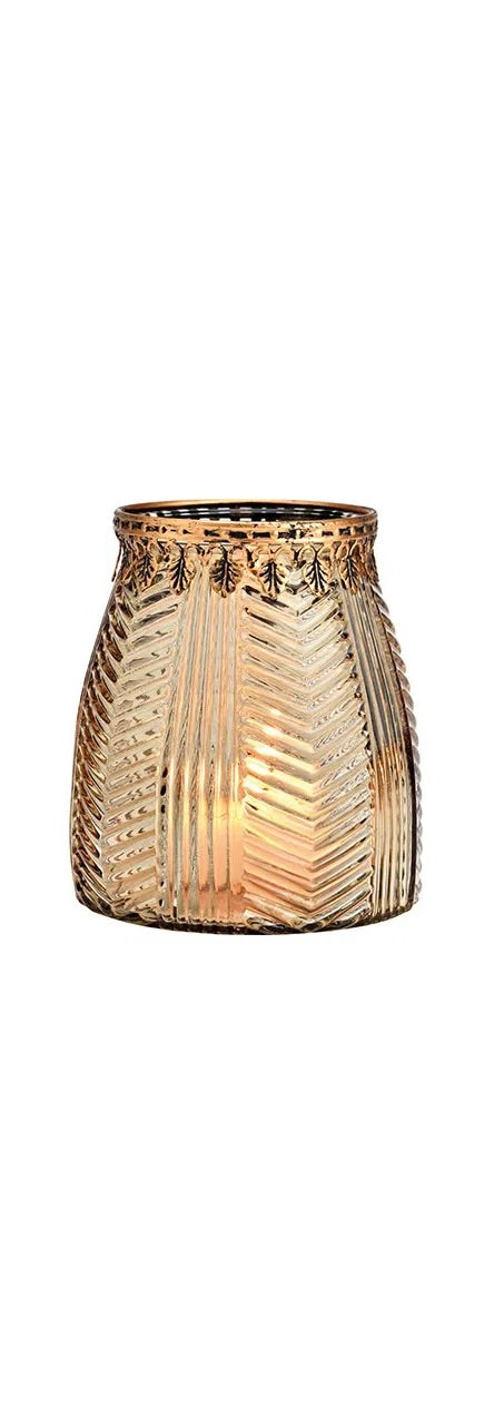 cylindrical brown glass windlight with geometric patterns, lit from the inside, showcasing a warm glow.