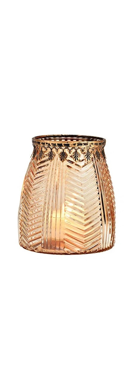 cylindrical brown glass windlight with geometric patterns, lit from the inside, showcasing a warm glow.