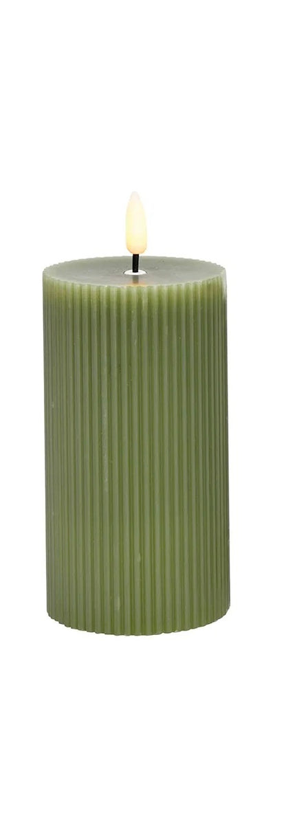 green LED wax candle with a flickering effect, in shape with a visible wick flame at the top.