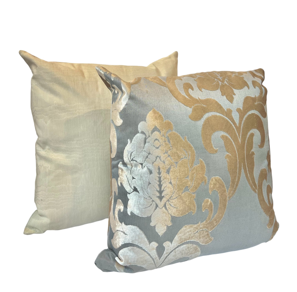 A beige satin pillow with a smooth texture and a floral Biege/Gold grey  floral pillow