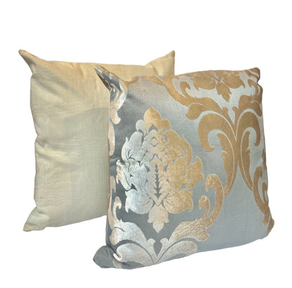 A beige satin pillow with a smooth texture and a floral Biege/Gold grey  floral pillow